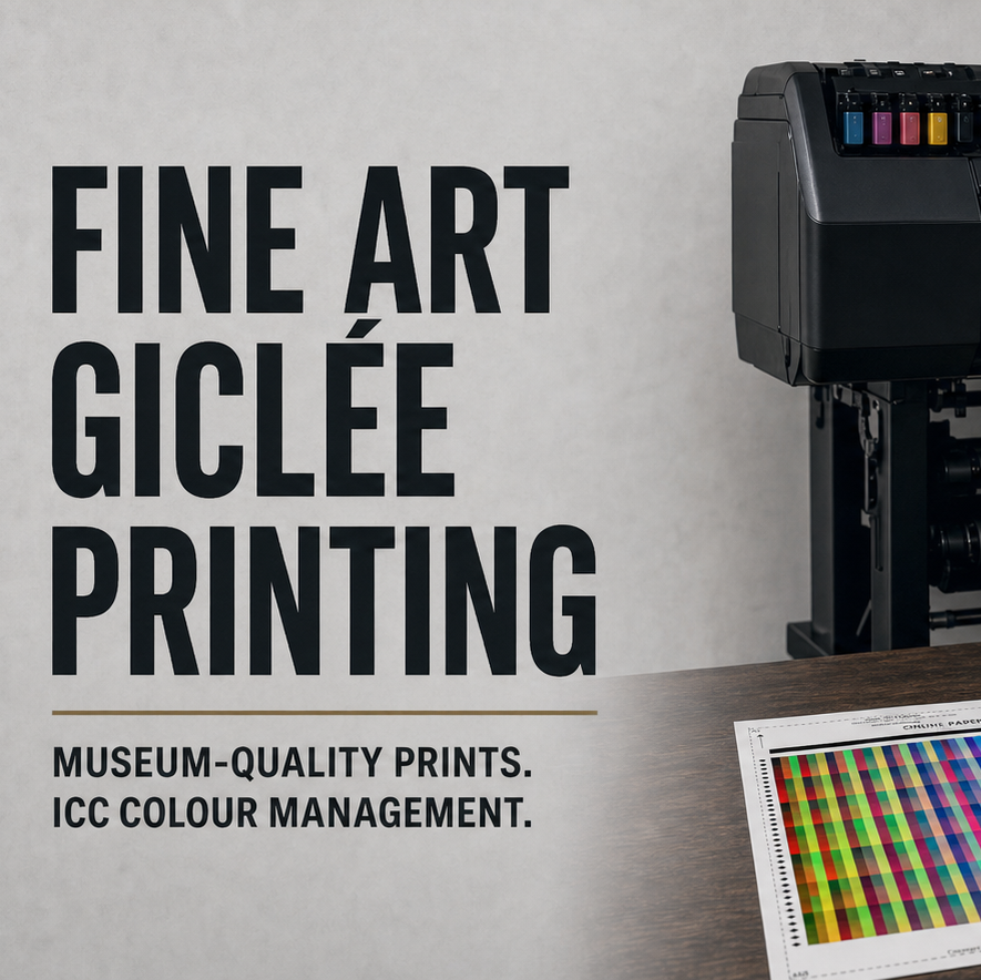 A large fine art printmaker desktop machine with a mountain landscape print emerging, shown beside a monitor displaying a color wheel and two printed color calibration charts on a table. Large text on the left reads 'FINE ART GICLÉE PRINTING' with smaller text below.