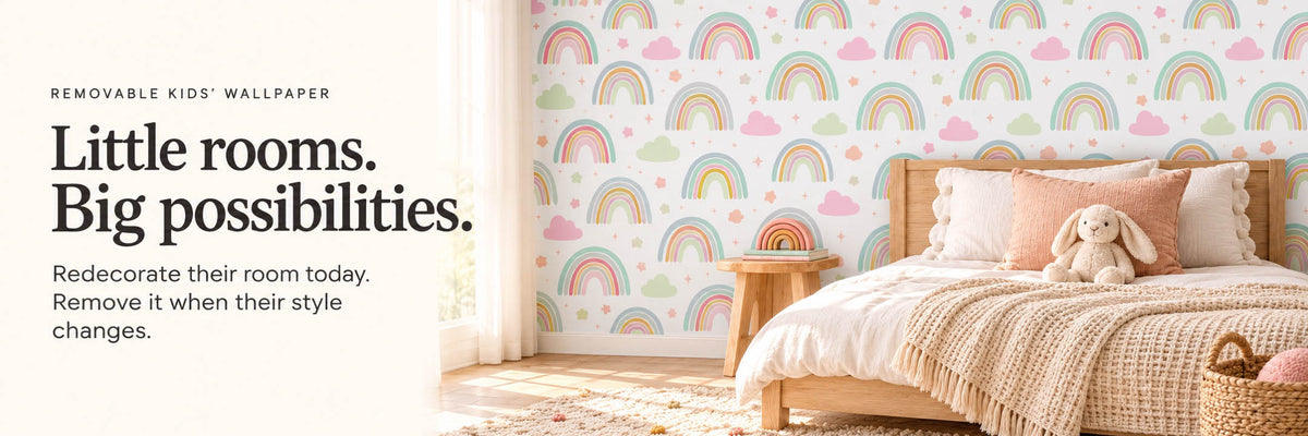 Rainbow and cloud peel-and-stick kids' wallpaper in a child's bedroom with a plush bunny