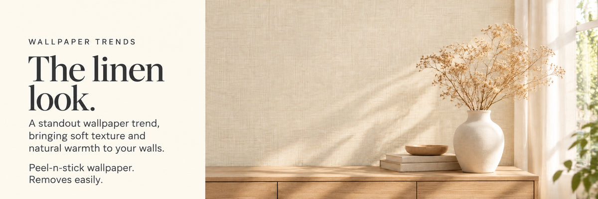 Linen-look peel-and-stick wallpaper behind a vase of dried flowers on a side table
