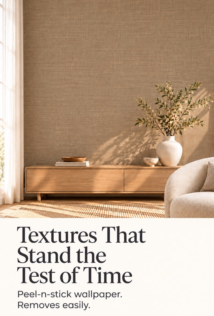 Textured tan peel-and-stick wallpaper behind a wood console with a vase and olive branches